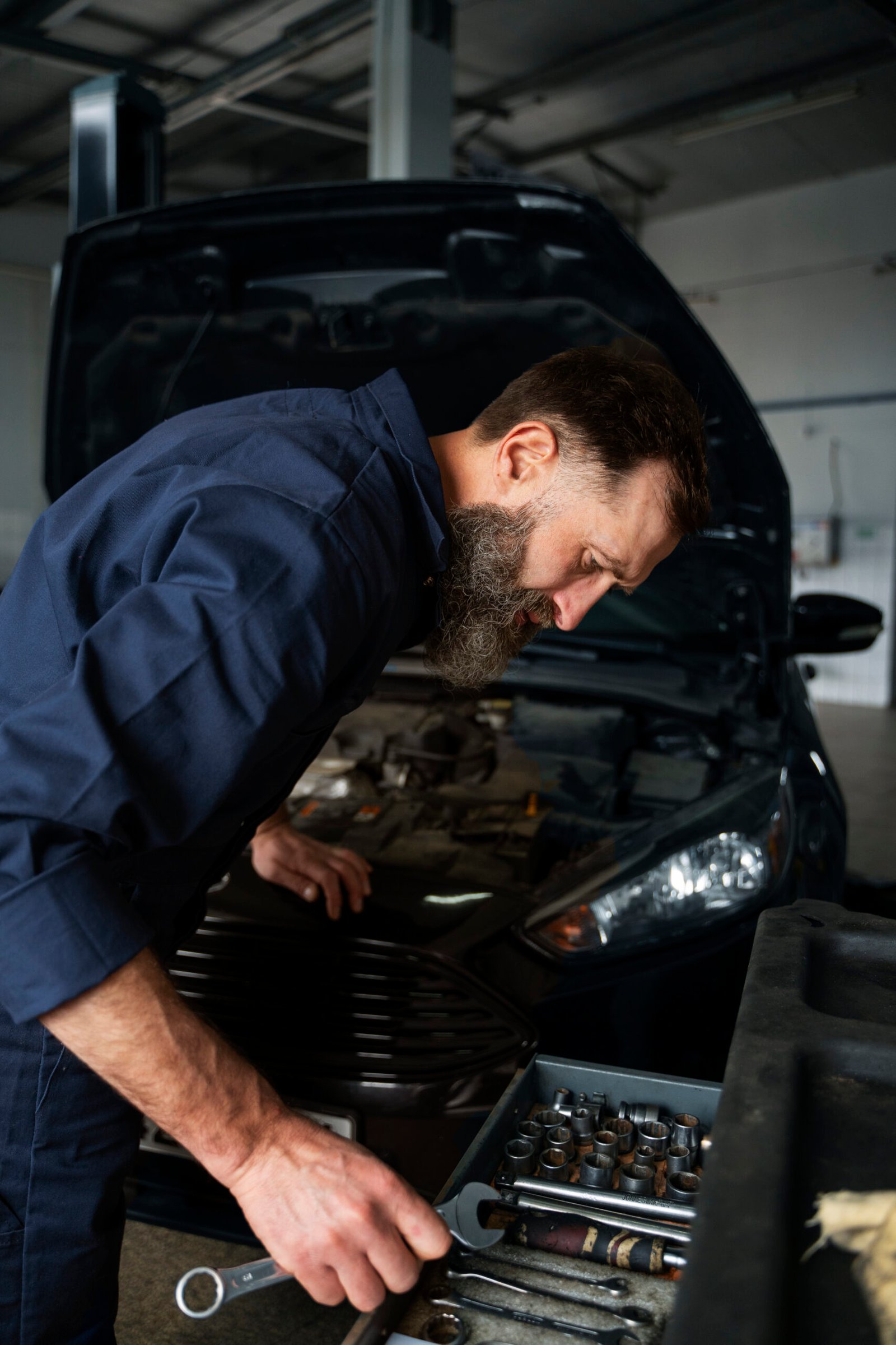 male-mechanic-working-auto-repair-shop-car